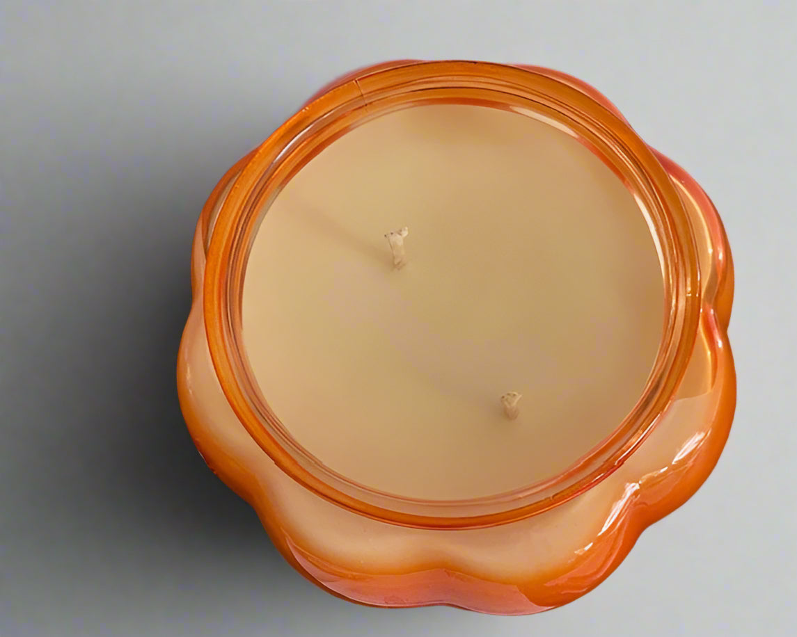 Orange 14 oz Pumpkin Souffle candle in a pumpkin-shaped glass jar